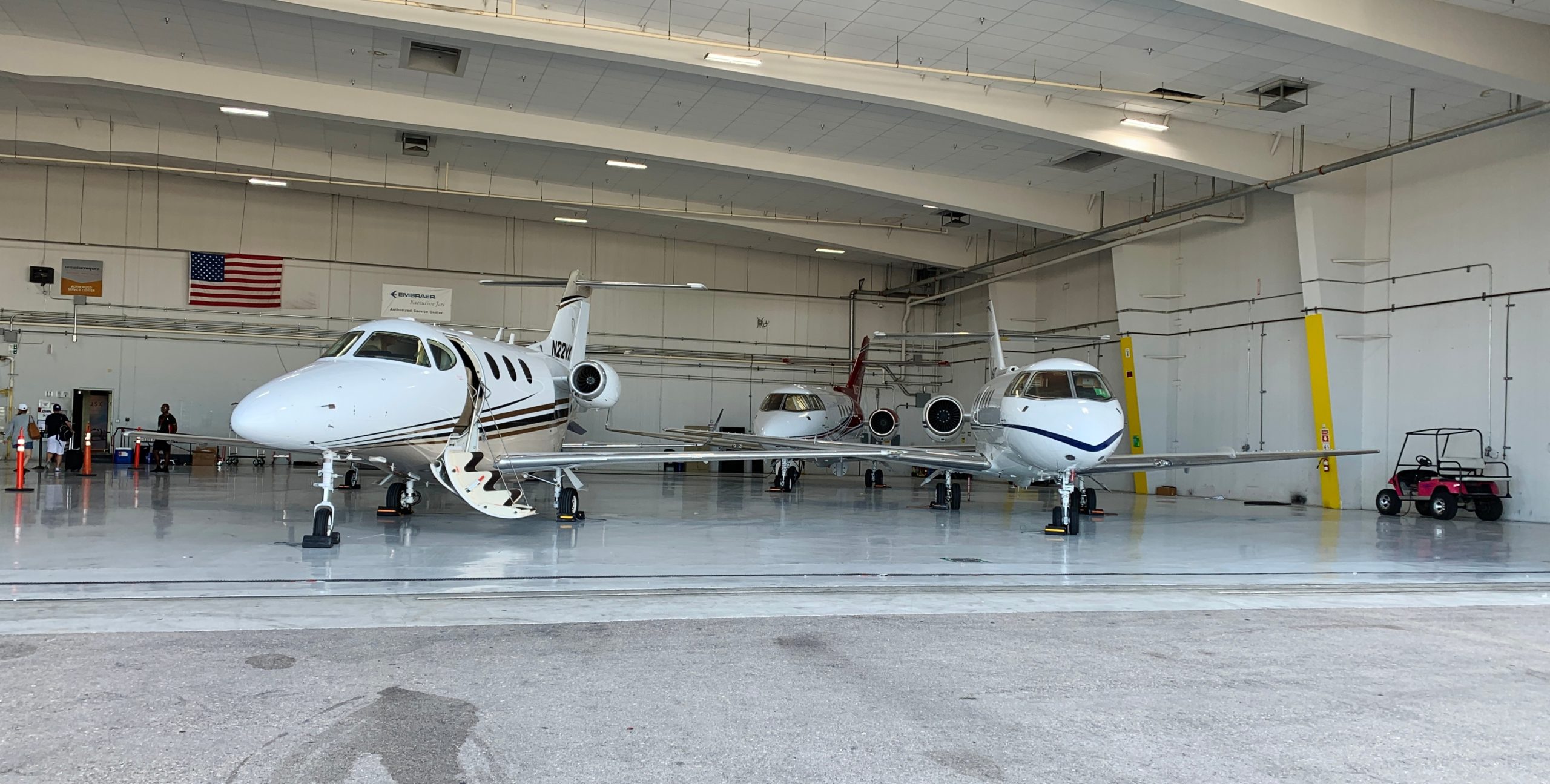 three-private-jets-in-an-airport-hanger-one-jet-p-2022-11-16-18-03-47-utc
